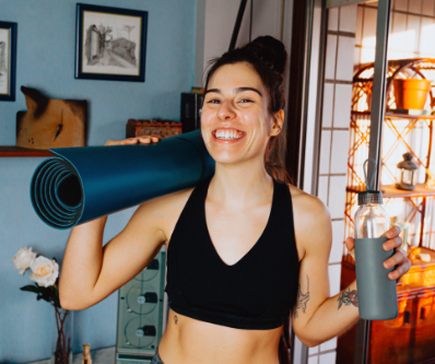 Smiling lady with a yoga mat